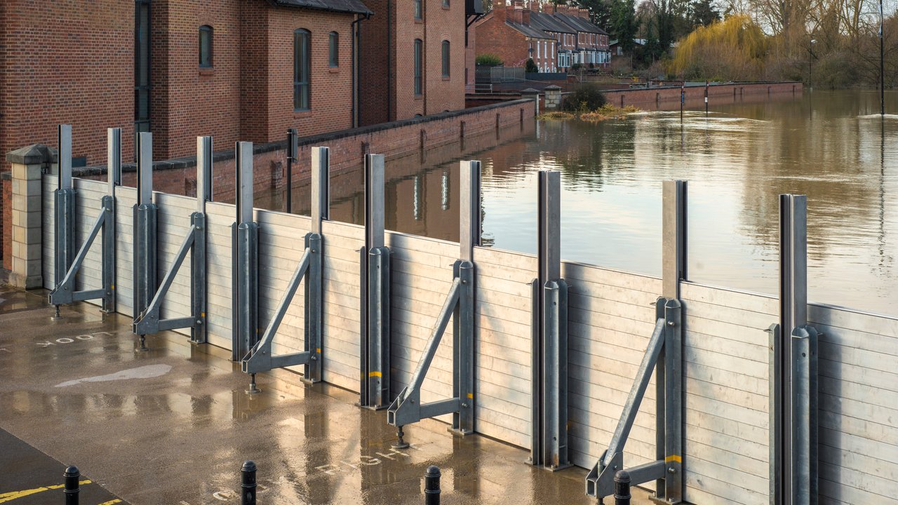 Demountable flood barrier in operation during winter flooding from the river Severn