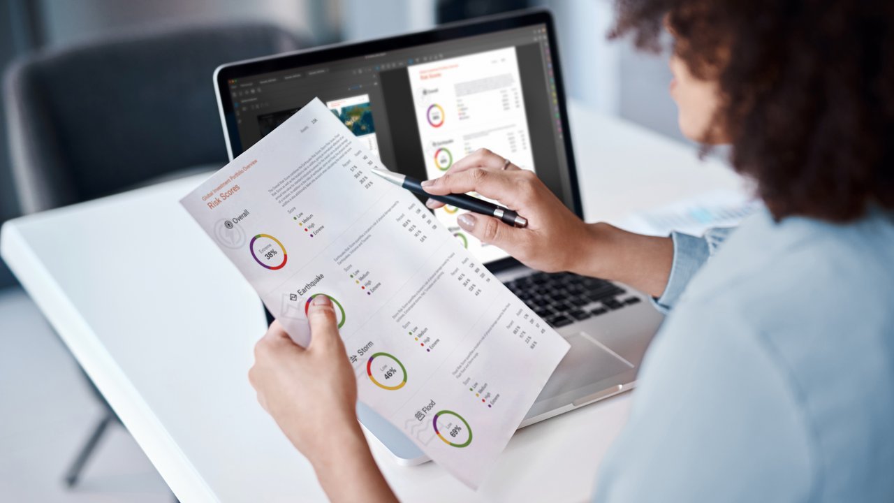 Woman on laptop reviewing global portfolio