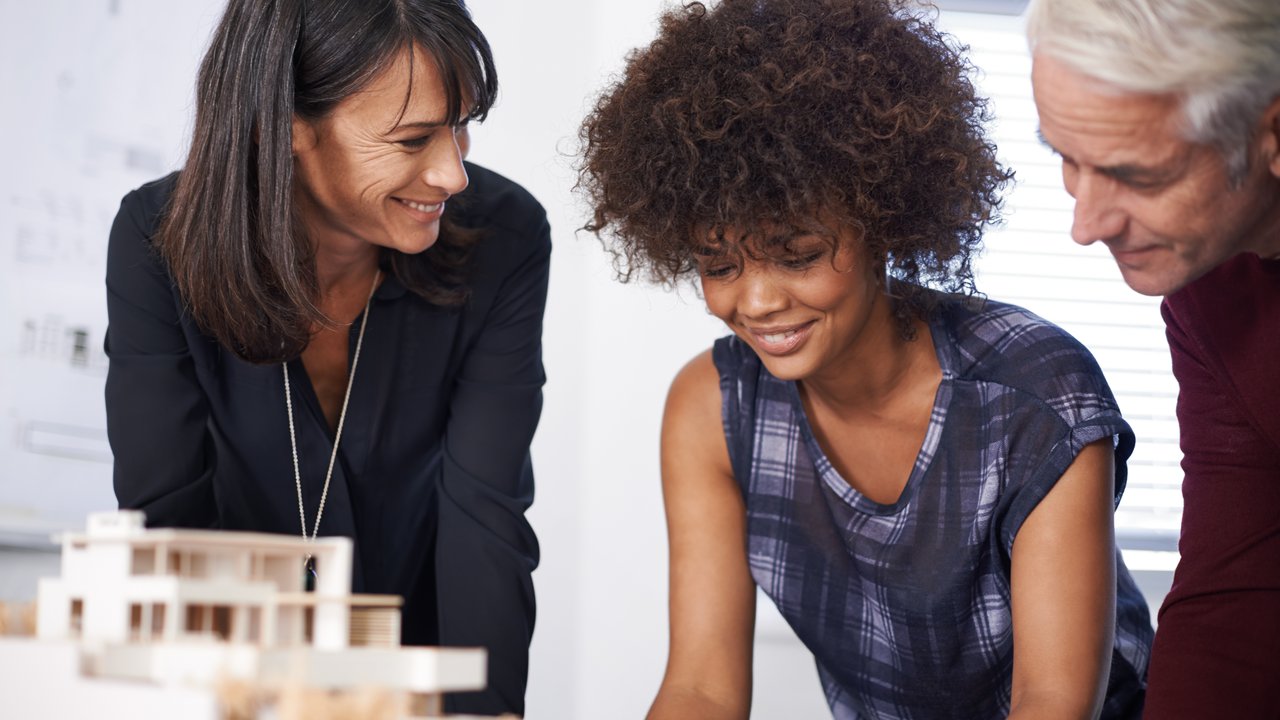 Two Womans and one man  at a meeting